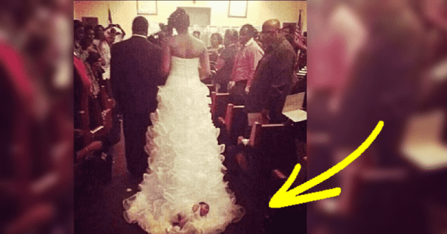 A Bride Has Sparked Outrage After Strapping Her Newborn Daughter Onto The Train Of Her Wedding Dress As She Walked Down The Aisle