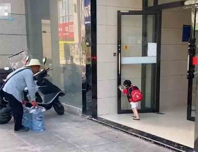 A 3-year-old Girl Opens the Door for an Elderly Man Delivering Gallons of Water