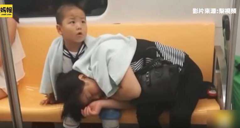 Tired Mom Falls Asleep In Chinese Subway, But Son Becomes A Guardian Of Her Rest